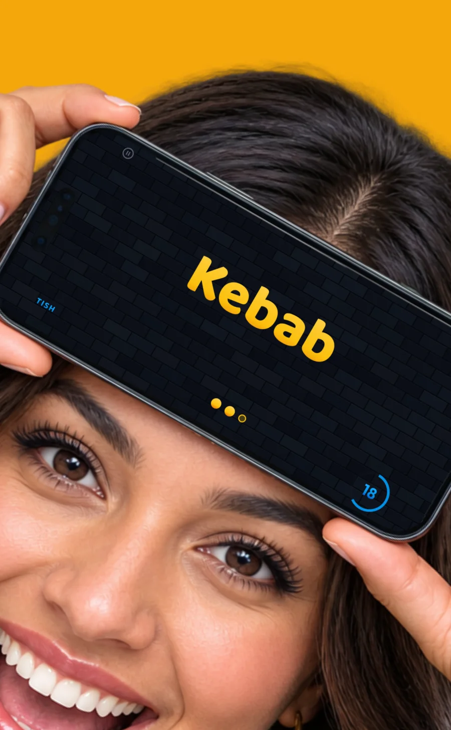A player laughing while holding a phone to their forehead showing the word Kebab